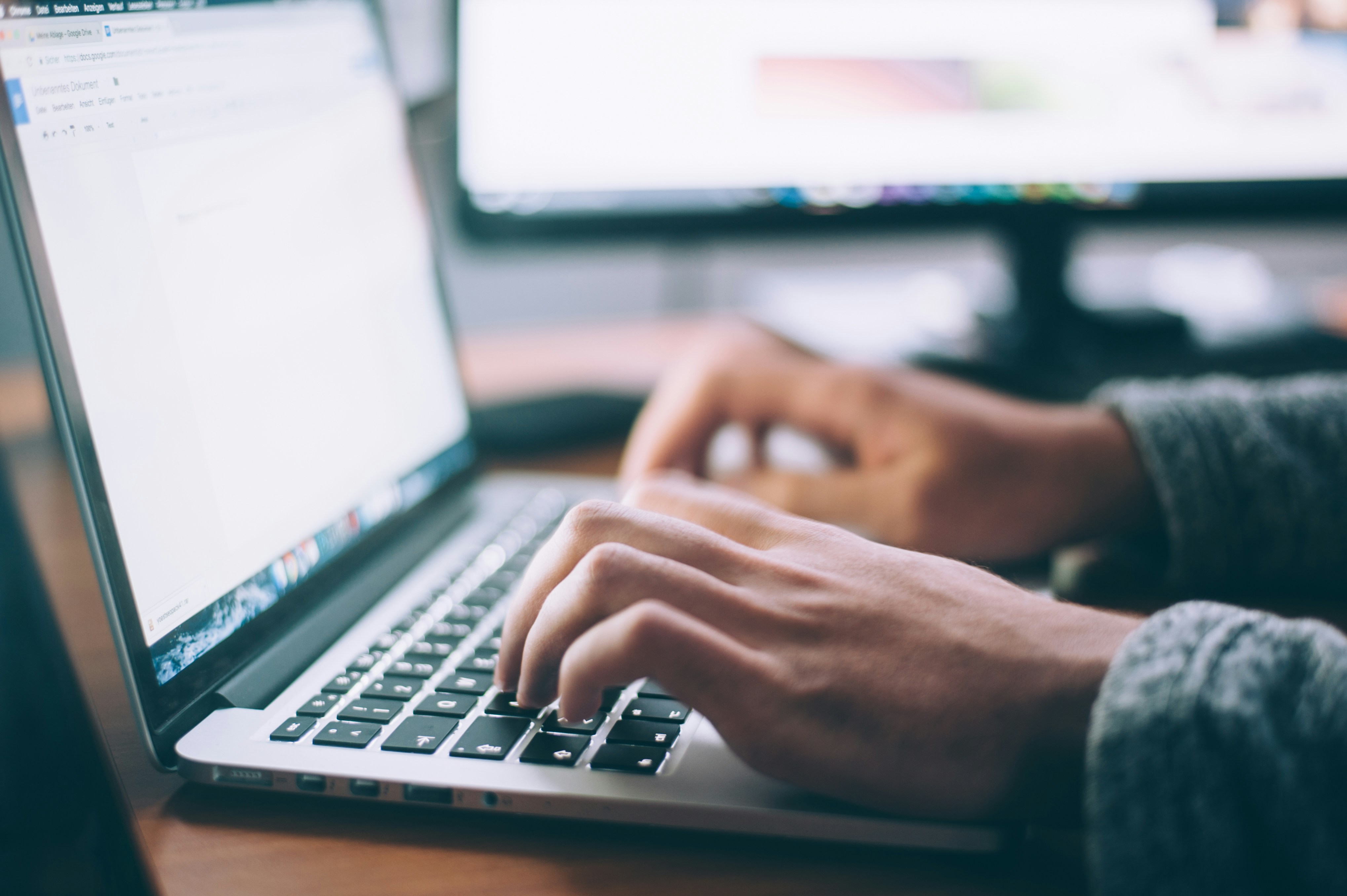 Man typing on a laptop.